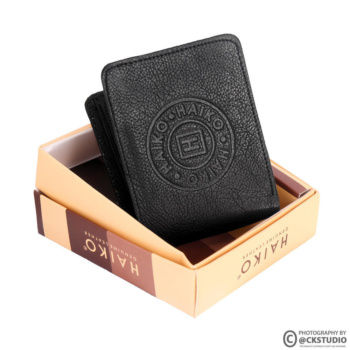 Shot of a black wallet in a box on a white background — Ckstudio; Commercial Product Photography.